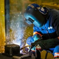 A male working with a welding torch